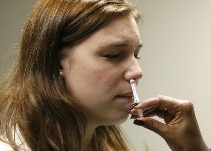 Student is given the H1N1 flu nasal spray vaccine in Washington